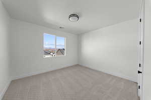 Empty room with light carpet and baseboards
