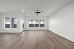 Unfurnished living room with wood finished floors, ceiling fan, and recessed lighting