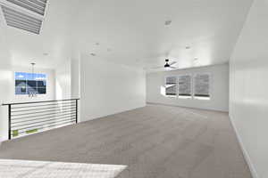 Empty room featuring light carpet and a ceiling fan