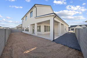 Back of property with a patio, stucco siding, and a fenced backyard