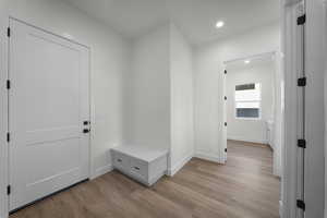 Mudroom with recessed lighting and light wood-type flooring