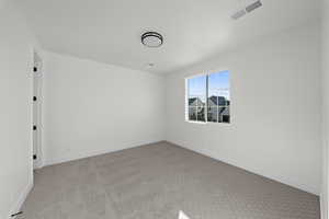 Unfurnished room with light carpet and baseboards