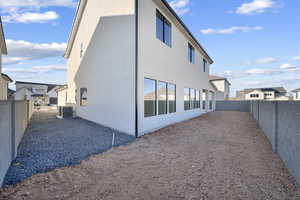 View of property exterior with a fenced backyard and stucco siding