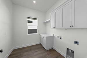 Laundry room featuring washer hookup, cabinet space, dark wood-type flooring, hookup for an electric dryer, and recessed lighting