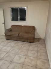 Living room with crown molding and tile patterned flooring