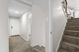 Stairs with carpet and recessed lighting