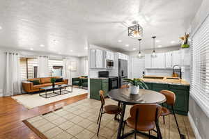 Dining area featuring a textured ceiling and recessed lighting