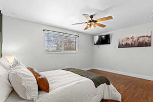Bedroom featuring wood finished floors and a ceiling fan