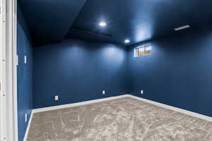 Empty room with carpet and recessed lighting