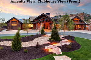 View of front facade with a standing seam roof, stone siding, and a chimney