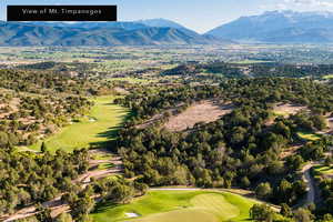 Aerial view of a golf club and a mountain backdrop