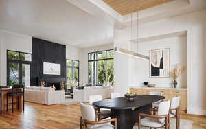 Dining area with light wood-type flooring, a large fireplace, and wood ceiling