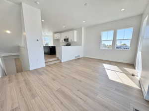 Unfurnished living room featuring recessed lighting and light wood-style floors