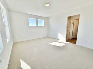 Empty room with carpet floors and baseboards