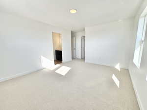 Unfurnished bedroom featuring carpet floors and connected bathroom