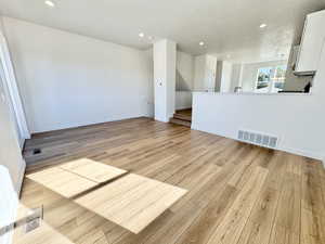 Unfurnished room with recessed lighting and light wood-type flooring