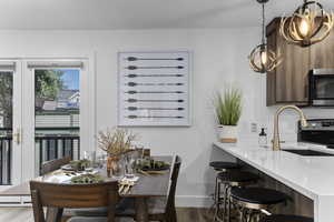 Dining area featuring light wood-style flooring and baseboards