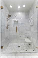 Bathroom with a stall shower and recessed lighting