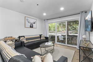Living area featuring wood finished floors and recessed lighting
