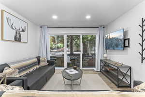 Living area with wood finished floors and recessed lighting