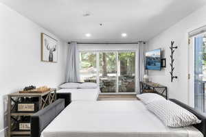 Bedroom with multiple windows and access to outside