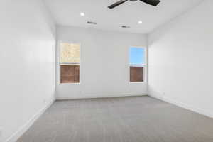 Spare room featuring light carpet, ceiling fan, and recessed lighting