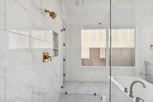 Bathroom with tiled shower and a soaking tub