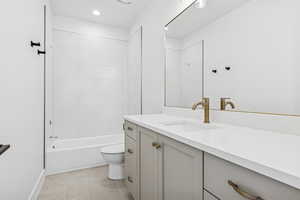 Bathroom featuring vanity, bathing tub / shower combination, recessed lighting, and light tile patterned flooring