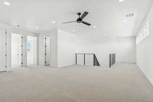 Empty room featuring recessed lighting, light carpet, and a ceiling fan