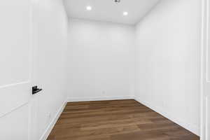 Spare room featuring dark wood-style flooring and recessed lighting