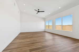Empty room featuring ceiling fan, light wood-style flooring, and recessed lighting