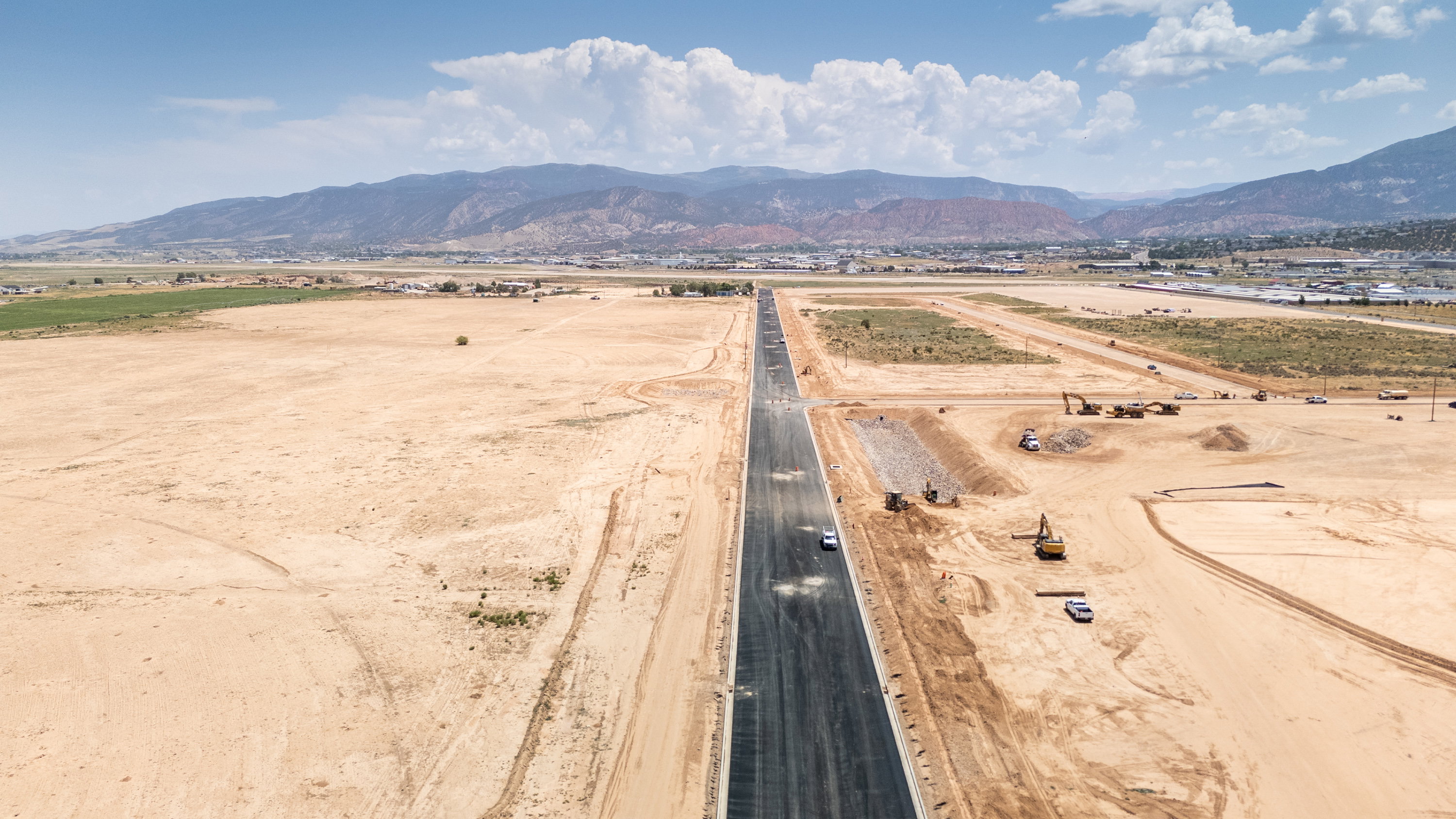 Aerial view of sparsely populated area with a mountainous background