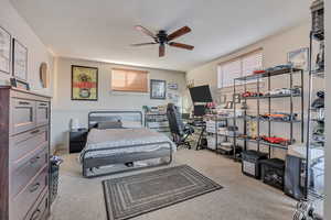 Bedroom featuring light carpet and a ceiling fan
