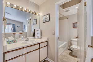Bathroom with vanity and shower / washtub combination