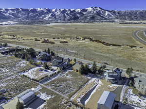 Snowy aerial view with a residential view and a mountain view