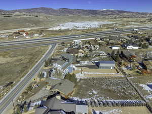 Snowy aerial view featuring a residential view and a mountain view