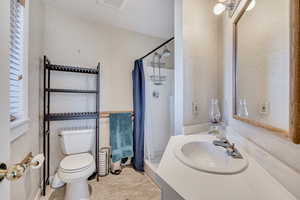 Full bath featuring a stall shower, vanity, and light tile patterned floors