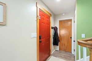 Entrance foyer featuring baseboards and light wood-style flooring