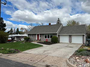 ** CHECK OUT THE NEW ROOF INSTALLED APRIL, 2026** View of front of house featuring a shingled roof, an attached garage, concrete driveway, and a front lawn