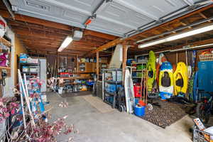 Garage with a workshop area and a garage door opener