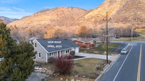 View of front facade featuring a mountain view, driveway, and a garage