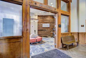 Living area featuring wood walls and recessed lighting