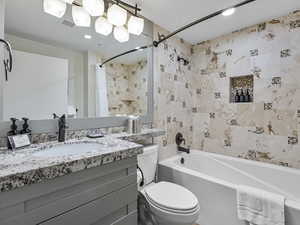 Full bathroom featuring shower / bath combo with shower curtain and vanity