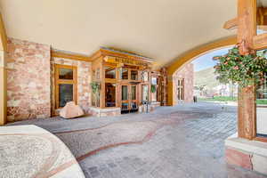Entrance to property with stone siding and french doors