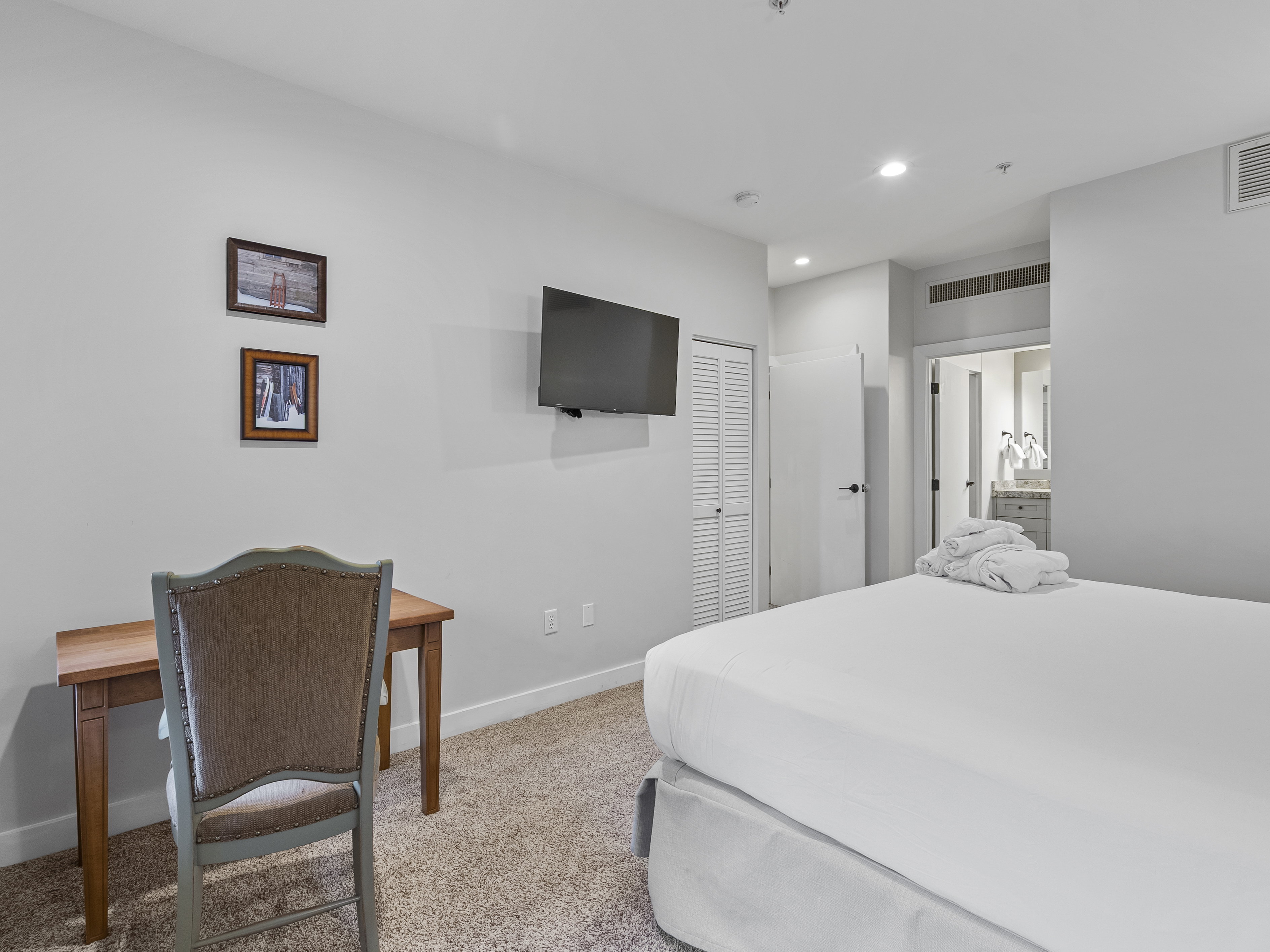 Bedroom with light carpet, a closet, and recessed lighting