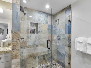 Bathroom with vanity, a stall shower, and recessed lighting