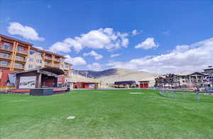 View of green lawn featuring a mountain view