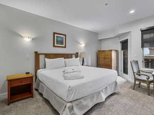 Carpeted bedroom featuring baseboards