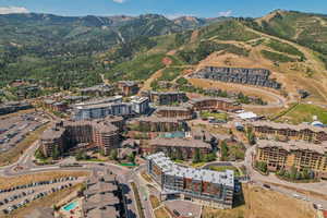Aerial view of property's location with a mountain backdrop and apartment complex / building
