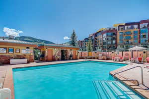 Community pool featuring a mountain view and a patio